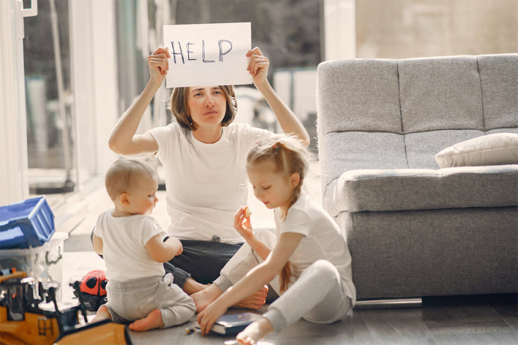 Photo of mom with "Help" sign